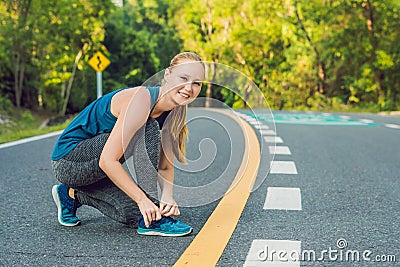 Female runner tying her shoes preparing for jogging outside .Young girld runner getting ready for training. Sport lifestyle Stock Photo