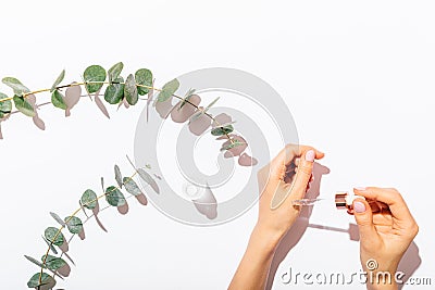 Female's hands holding eyedropper Stock Photo