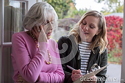 Female Sales Person Trying To Persuade Senior Woman To Purchase Stock Photo