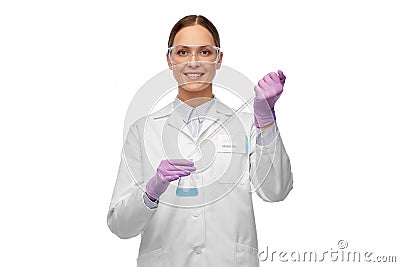 Female scientist in goggles with chemical in flask Stock Photo