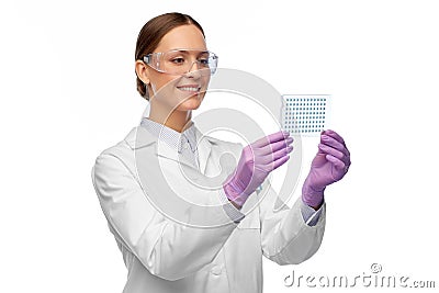 Female scientist in goggles with chemical sample Stock Photo