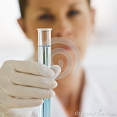 Female Scientist holding up Test Tube Stock Photo
