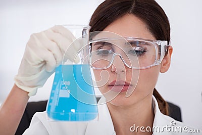 Female Scientist Holding Chemical Stock Photo