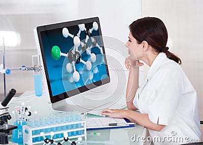 Female scientist looking on computer screen Stock Photo