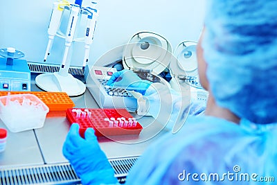 Female scientist makes PCR DNA tests in a modern chemical and bacteriological laboratory. Stock Photo
