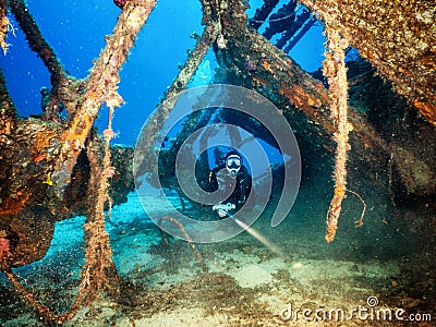 Female scuba diver explores a sunken wreck Stock Photo