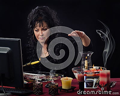 Female seer doing candle wax reading online Stock Photo