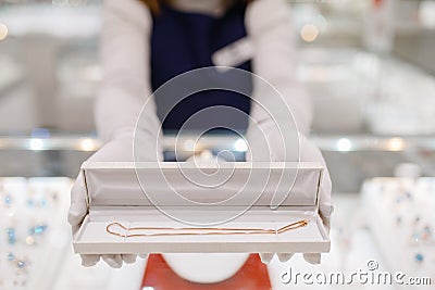 Female seller hands with gold bracelet in the case Stock Photo