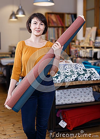 Female seller organizing assortment in fabric store Stock Photo
