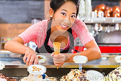 Female seller in Parlor with ice cream cone Stock Photo