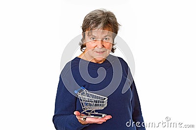 Female senior holding empty model shopping trolley Stock Photo