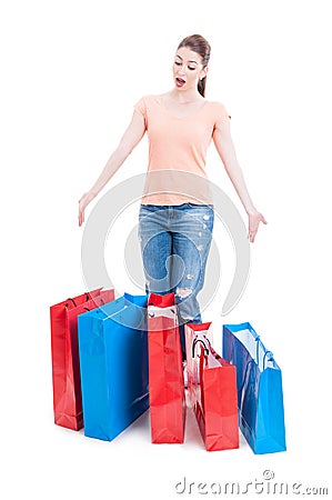 Female shopper standing and feeling enthusiastic with many shopping bags Stock Photo