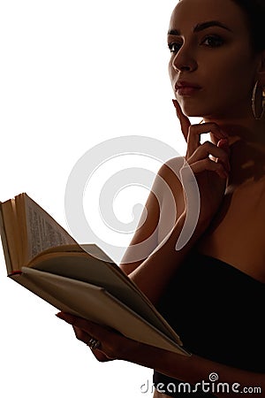 female silhouette reading pensive woman with book Stock Photo