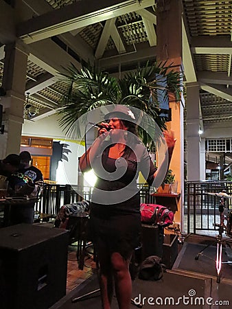 Female singer from Guidance Band sings on stage at Mai Tai Bar Editorial Stock Photo