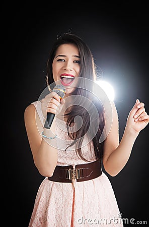 Female singer sings into a microphone Stock Photo