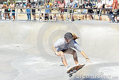 Female skateboarder shredding the course. Editorial Stock Photo
