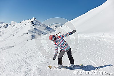 Female snowboarder in the Alps, sunny mountain landscape Stock Photo