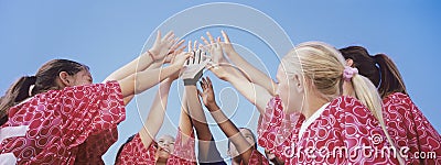 Female Soccer Team High-Fiving Stock Photo