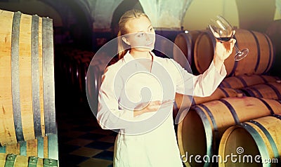 Female sommelier in wine cellar Stock Photo