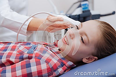 Female sonographer providing ultrasonic examination in the clinic Stock Photo