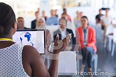 Female speaker speaks in a business seminar Stock Photo