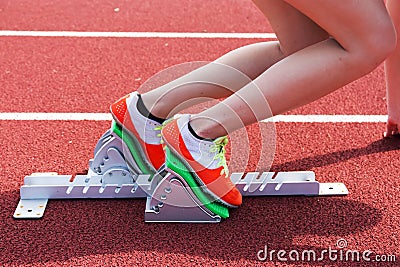 Female sprinter in the blocks Stock Photo