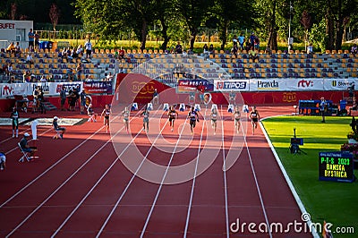 Female Sprinters Navigate 100m Race with Grace in Enchanting Twilight Setting at Track and Editorial Stock Photo