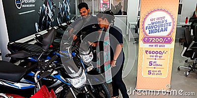 female staff displaying motorcycle latest model into the bajaj showroom in India aug 2019 Editorial Stock Photo