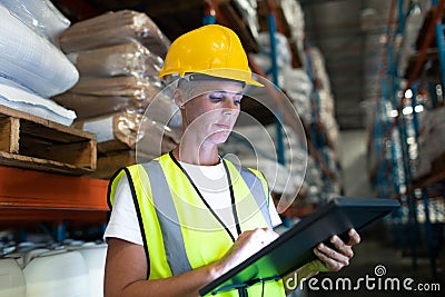 Female staff using digital tablet in warehouse Stock Photo