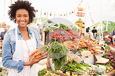 Female Stall Holder At Farmers Fresh Food Market Stock Photo