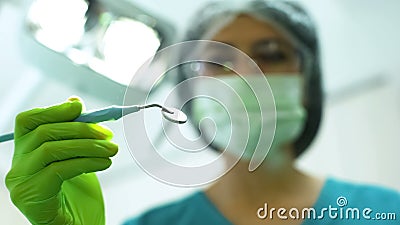 Female stomatologist preparing to exam patient teeth, treatment of toothache Stock Photo