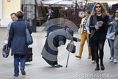 Female street begger in busy street of Moscow near metro Arbatskaya Editorial Stock Photo