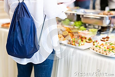 Female student choosing finger food from buffet table Stock Photo