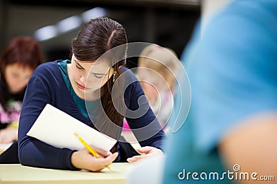 Female student sitting in a classroom Stock Photo