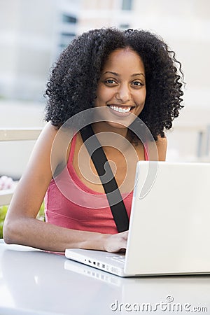 Female student using laptop outside Stock Photo