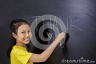 Female student writing Thank You text Stock Photo