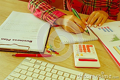 Female Studying Plans In Office. Business woman working at the office. calculating or checking balance. Business plan, finances, i Stock Photo