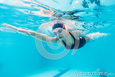 Female swimmer gushing through water in pool Stock Photo