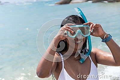 Female Swimmer Smiling And Putting On Snorkeling Goggles Stock Photo