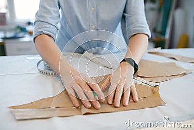 Female Tailor Making Sewing Patterns On Table Stock Photo