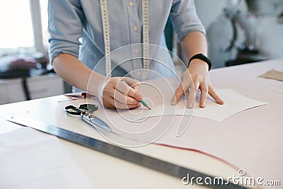 Female Tailor Making Sewing Patterns On Table Stock Photo