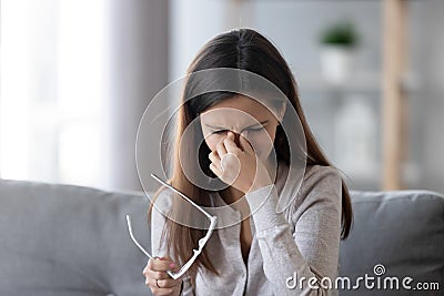 Female take off glasses massaging nose bridge feeling eye strain Stock Photo