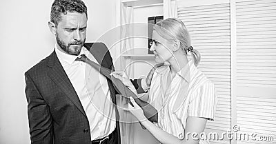 Female take sexual initiative. Office and sexual behavior. Woman hold mans necktie. Girl seduce colleague. Sexual Stock Photo