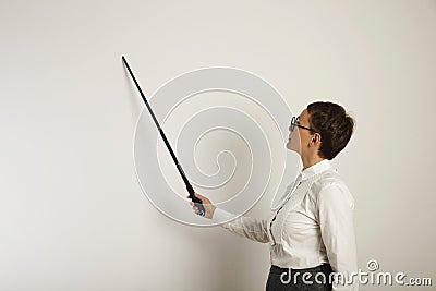 Female teacher with a pointer at white board Stock Photo