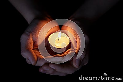 Female teen hands holding burning candle Stock Photo