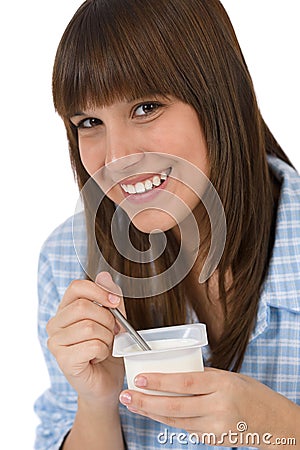 Female teenager eat healthy yogurt for breakfast Stock Photo