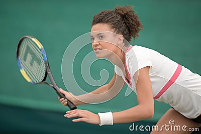 female tennis player poised to return ball Stock Photo