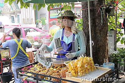 Female thai street vendor selling sliced pineapple in Bangkok, Thailand Editorial Stock Photo