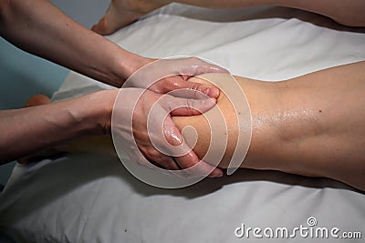 A right calf massage by therapist Stock Photo