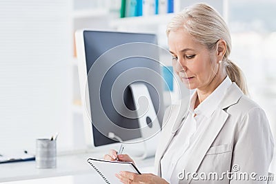 Female therapist writing notes Stock Photo